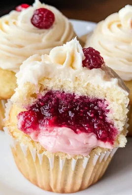 Almond Wedding Cake Cupcakes with Raspberry Filling